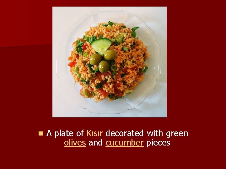 n A plate of Kısır decorated with green olives and cucumber pieces 