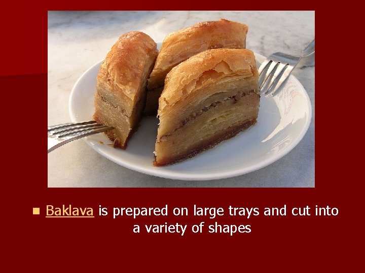 n Baklava is prepared on large trays and cut into a variety of shapes