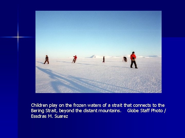 Children play on the frozen waters of a strait that connects to the Bering