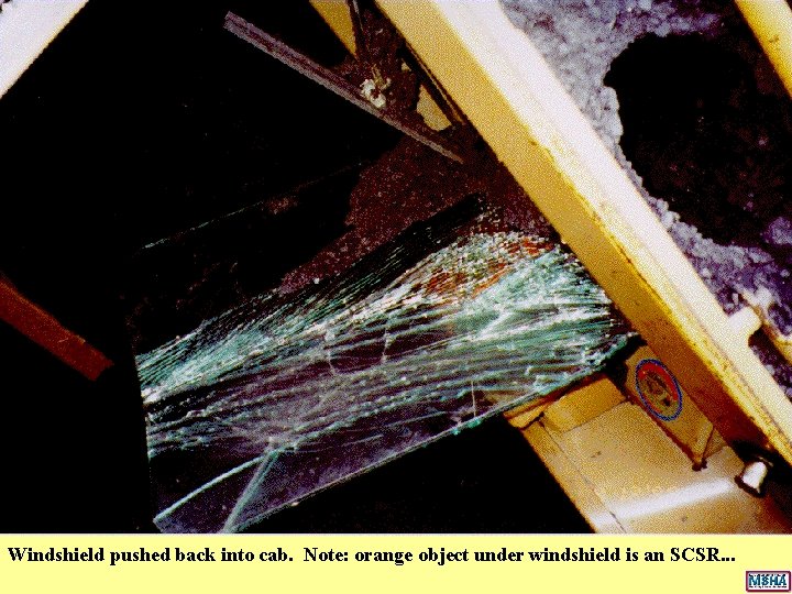 Windshield pushed back into cab. Note: orange object under windshield is an SCSR. . Windshield pushed back into cab. Note: orange object under windshield is an SCSR. .