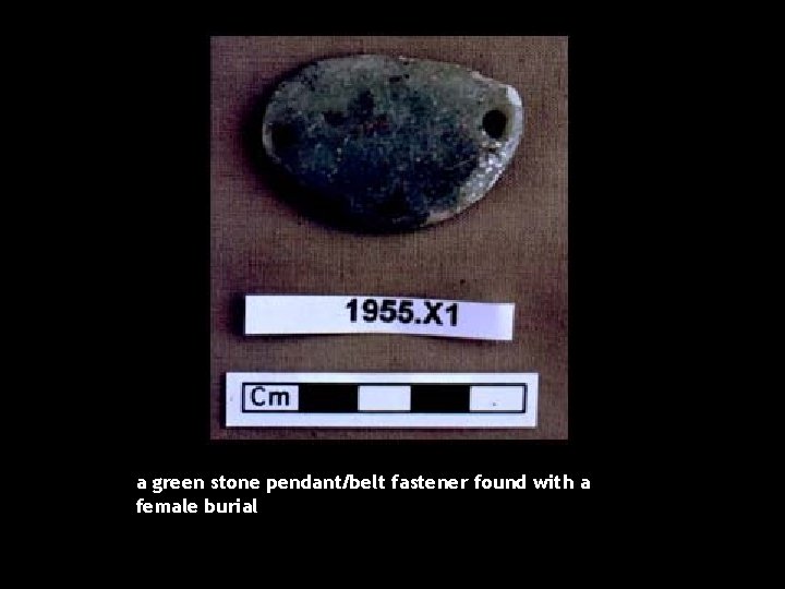 a green stone pendant/belt fastener found with a female burial 