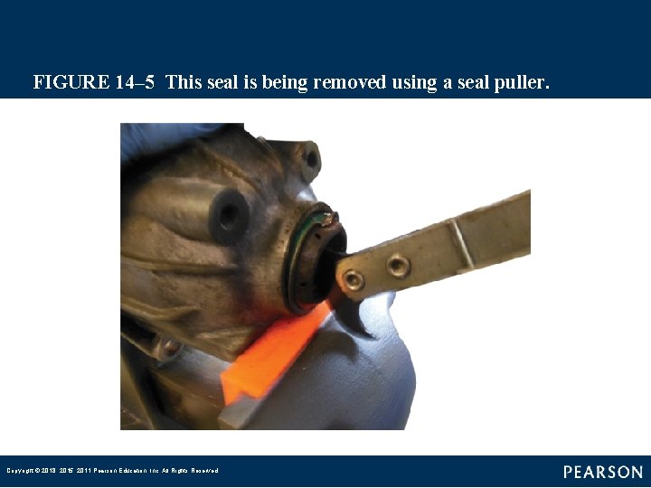 FIGURE 14– 5 This seal is being removed using a seal puller. Copyright ©