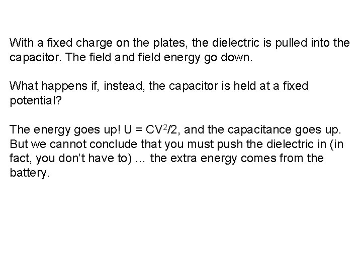 With a fixed charge on the plates, the dielectric is pulled into the capacitor.