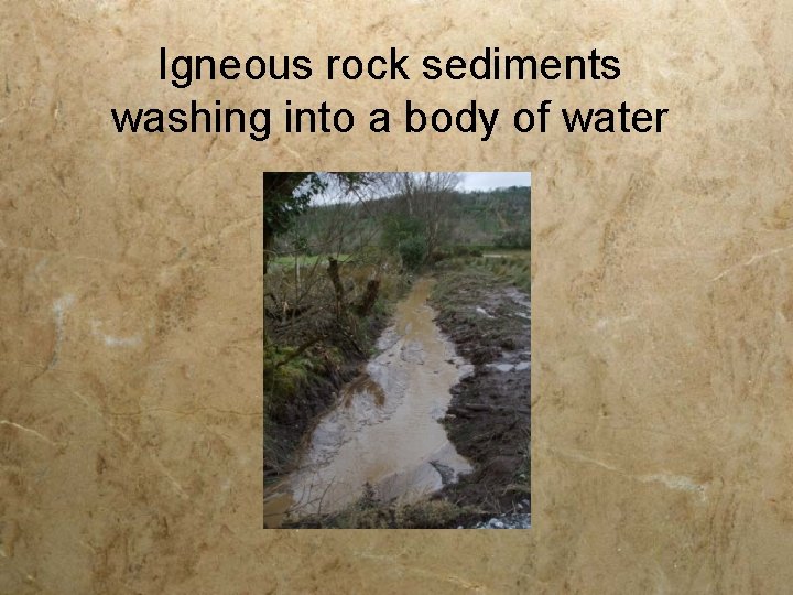 Igneous rock sediments washing into a body of water 