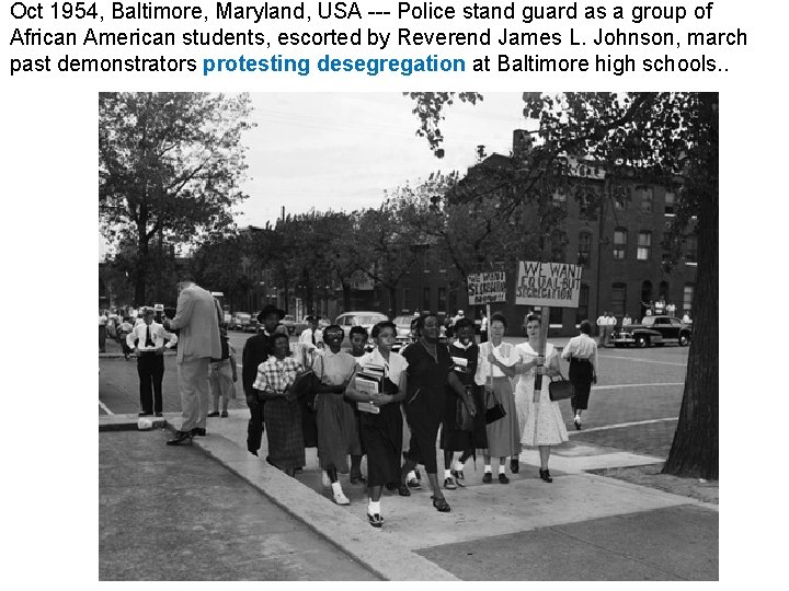 Oct 1954, Baltimore, Maryland, USA --- Police stand guard as a group of African Oct 1954, Baltimore, Maryland, USA --- Police stand guard as a group of African
