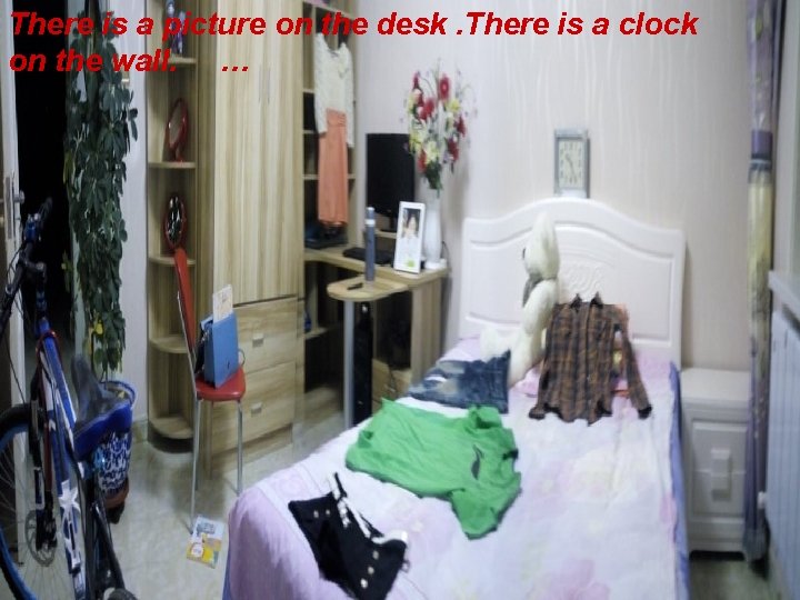 There is a picture on the desk. There is a clock on the wall.