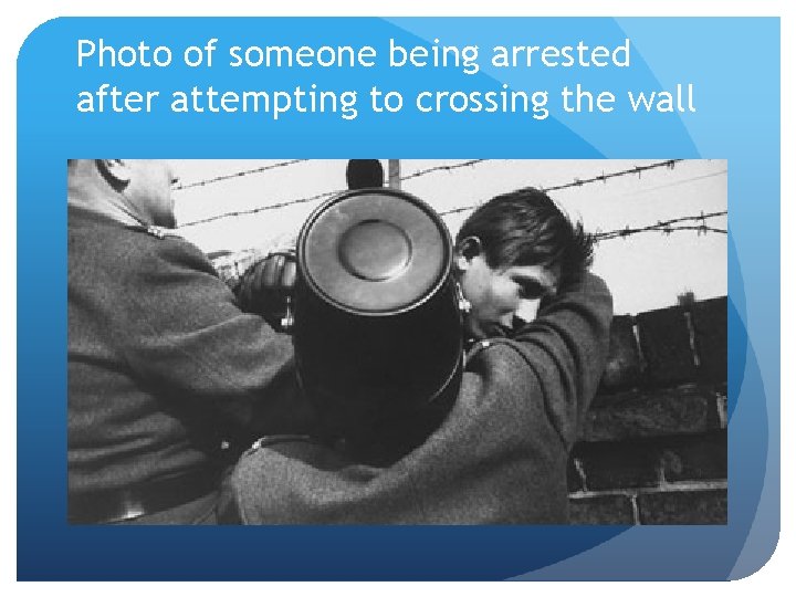 Photo of someone being arrested after attempting to crossing the wall 