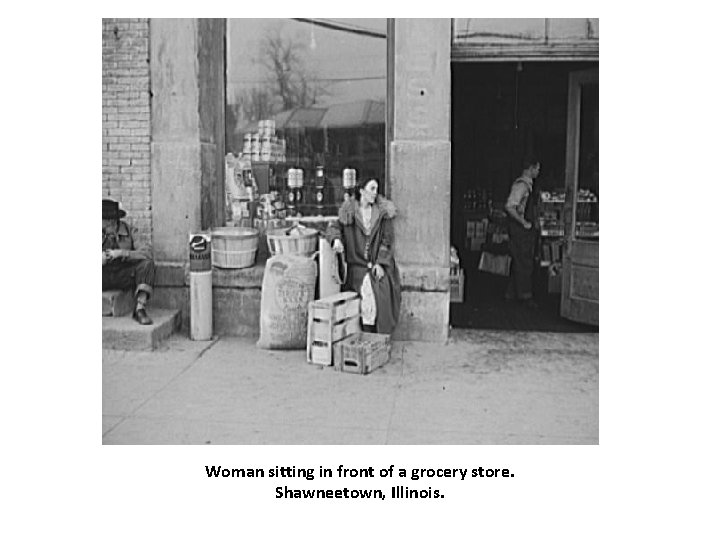 Woman sitting in front of a grocery store. Shawneetown, Illinois. 