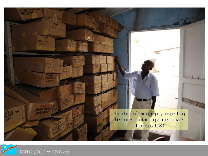 The chief of cartography inspecting the boxes containing ancient maps of census 1984 RGPH