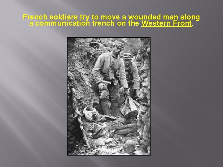 French soldiers try to move a wounded man along a communication trench on the