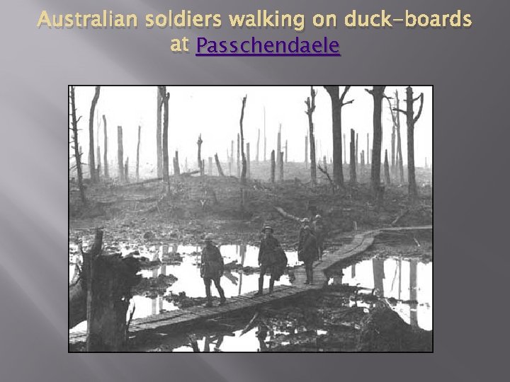 Australian soldiers walking on duck-boards at Passchendaele 