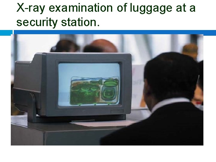 X-ray examination of luggage at a security station. 