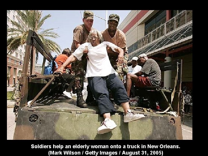 Soldiers help an elderly woman onto a truck in New Orleans. (Mark Wilson /