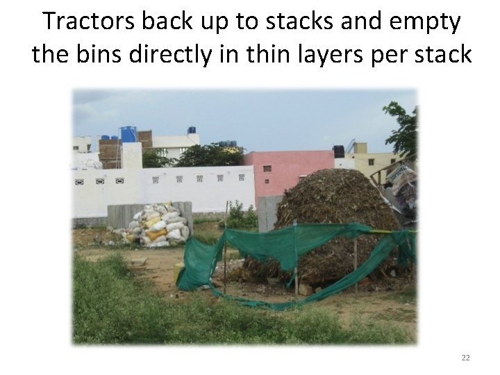 Tractors back up to stacks and empty the bins directly in thin layers per