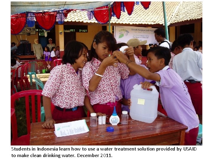 Students in Indonesia learn how to use a water treatment solution provided by USAID