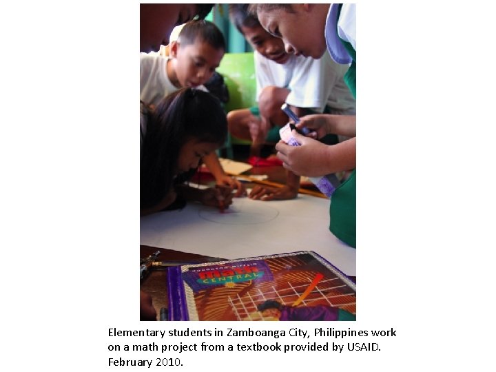 Elementary students in Zamboanga City, Philippines work on a math project from a textbook