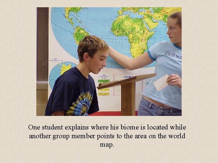 One student explains where his biome is located while another group member points to