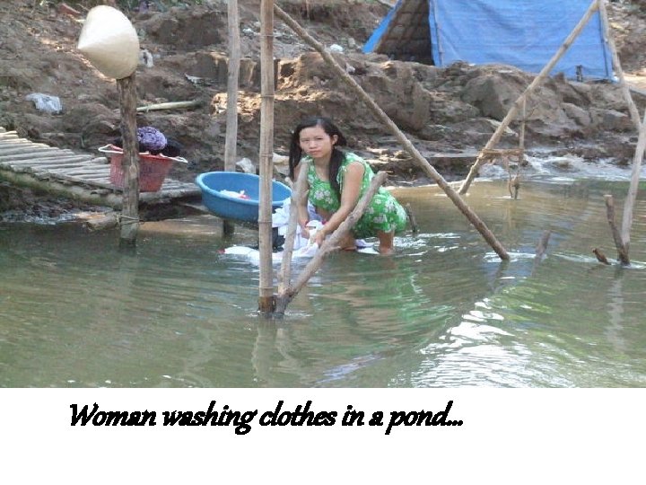 Woman washing clothes in a pond… 