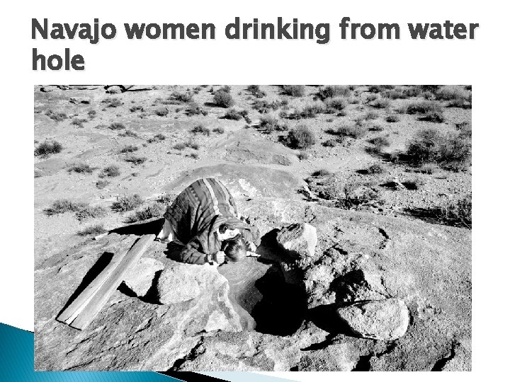 Navajo women drinking from water hole 