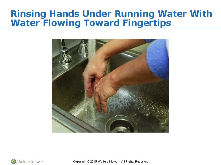 Rinsing Hands Under Running Water With Water Flowing Toward Fingertips Copyright © 2015 Wolters