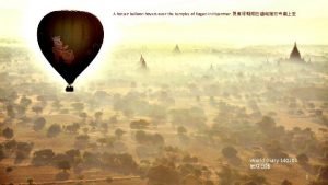 A hot air balloon hovers over the temples
